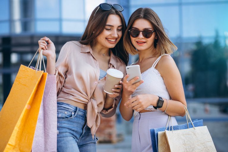 Two beautiful women shopping in town