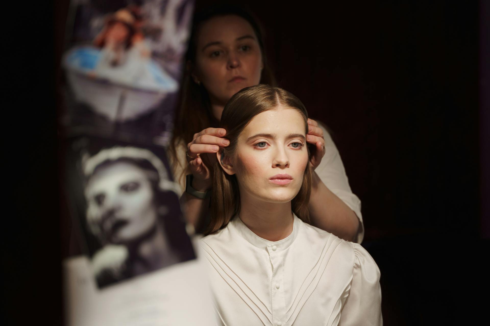 A stylist prepping a model backstage.