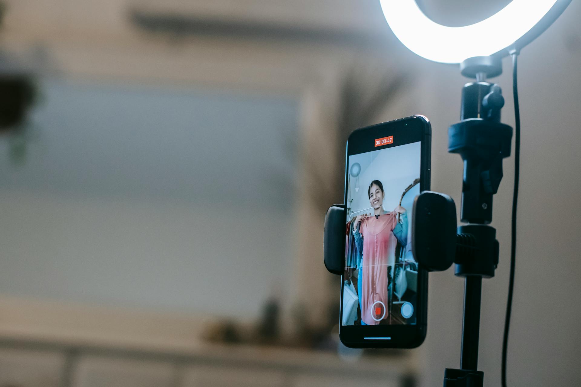 Woman filming herself in a dress.